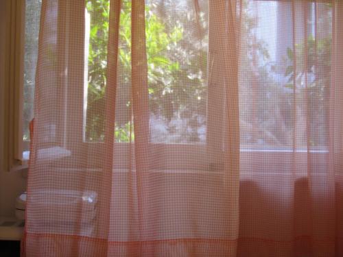 a window with orange curtains in a room at Apartment Petrović in Korčula