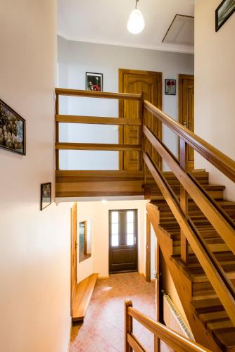 a hallway with wooden stairs in a house at Holiday Home Ermine in Sigulda