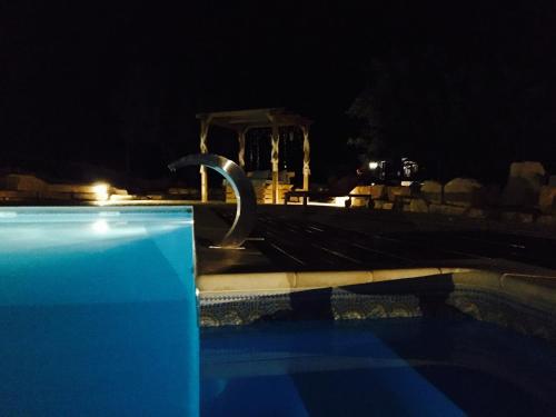 a swimming pool at night with a water park at Villa Monte da Alfarrobeira in Estói