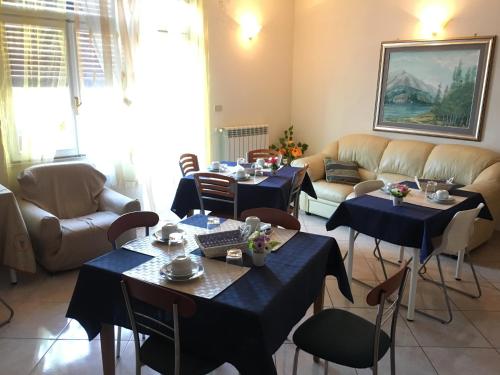 a living room with two tables and a couch at Altea in Pescara