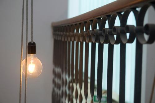 a light bulb hanging from a rail next to a window at Mon hotel in Ciutadella