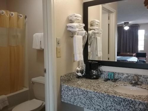 a bathroom with a sink and a mirror at Americas Best Value Inn Blue Ridge in Blue Ridge