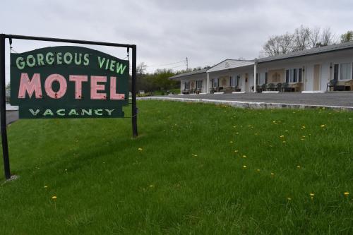 a sign in the grass in front of a motel at Gorgeous View Motel in Watkins Glen