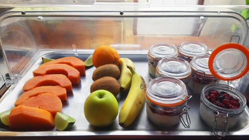 a tray of vegetables and fruit on a table at Hibiscus Beach House in Willemstad