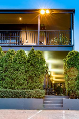 a building with a balcony with plants on it at Barkly Motorlodge in Ballarat