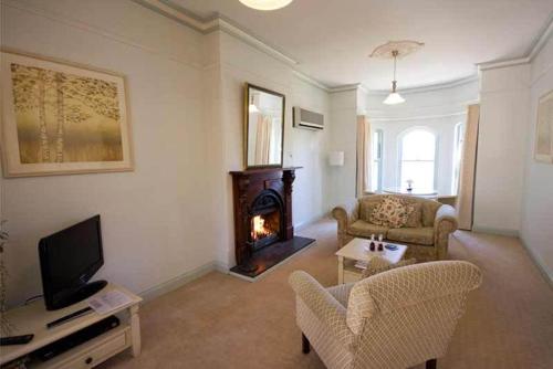 a living room with a couch and a fireplace at Brice Hill Country Lodge in Clare