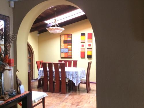 a dining room with a table and chairs at Quito Kawsay in Quito
