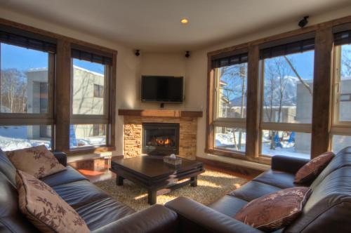 a living room with a couch and a fireplace at Gouka Chalet in Kutchan