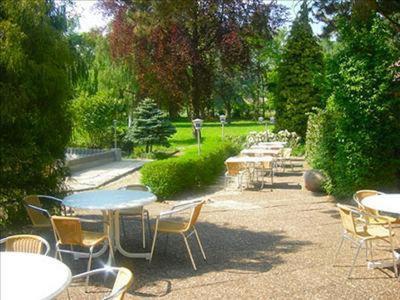 a group of tables and chairs in a park at Hotel Royal Garden in Bad Iburg
