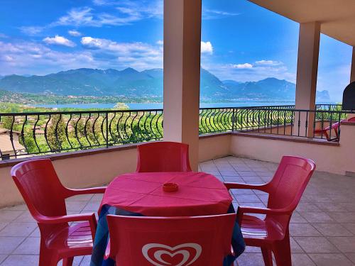 a table and chairs with a view of a vineyard at Residence Bellavista in Manerba del Garda