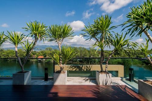 a view from the balcony of a house with palm trees at The Peak in Chanthaburi