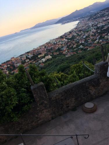 a view of a city and the ocean at sunset at Blu Oltremare in Borgio Verezzi