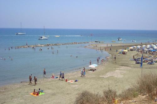 a group of people on a beach in the water at Periyiali Beach Sunset Suite A7 in Pervolia
