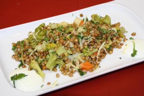 a white plate of food with broccoli and beans at Biolandhaus Arche in Eberstein