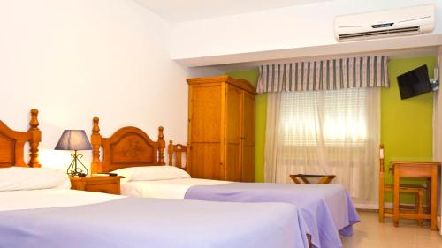 Un ou plusieurs lits dans un hébergement de l'établissement Hostal Restaurante El Mirador