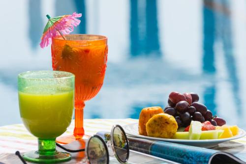 a table with a plate of fruit and a drink at U Boutique Kinneret by the Sea of Galilee in Tiberias
