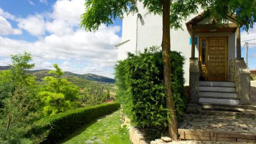 a small white church with a stairway leading up to it at Hospedium Hostal Restaurante El Mirador de Atienza in Atienza