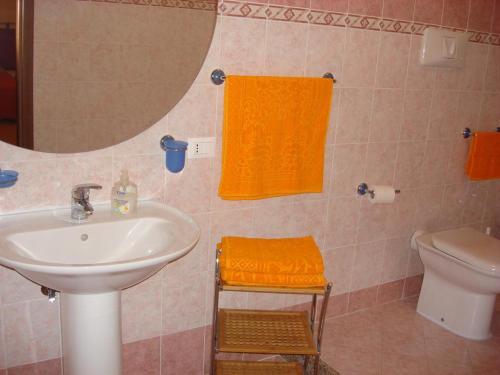 a bathroom with a sink and a toilet and a mirror at B&B Il Gabbiano in Reggio Calabria