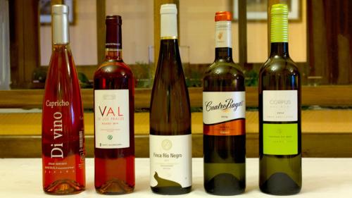 a group of four bottles of wine on a table at Hospedium Hostal Restaurante El Mirador de Atienza in Atienza