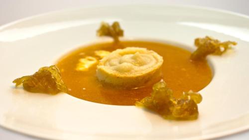 a white plate with a dish of food on it at Hospedium Hostal Restaurante El Mirador de Atienza in Atienza