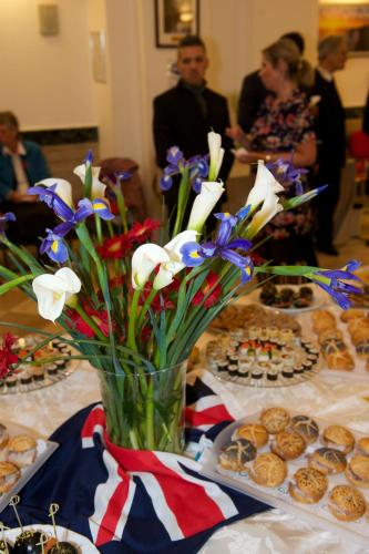 a vase filled with flowers on a table with food at Domus Australia in Rome