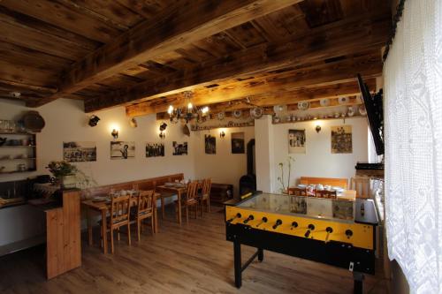 a dining room with a ping pong table in the middle at Ubytovanie Zuzana in Smižany