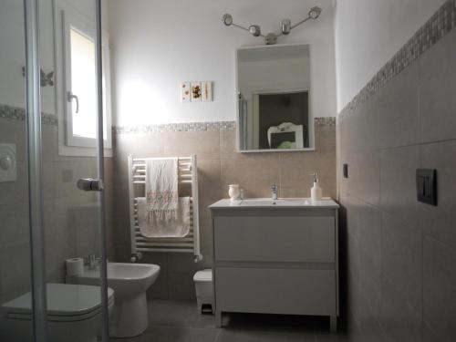 a bathroom with a sink and a toilet and a mirror at Tenuta Sperlinga - Il Campanile in Santa Flavia