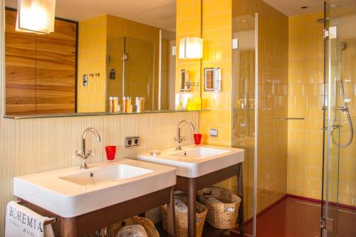 a bathroom with two sinks and a shower at Bohemia Suites & Spa - Adults Only in Playa del Ingles