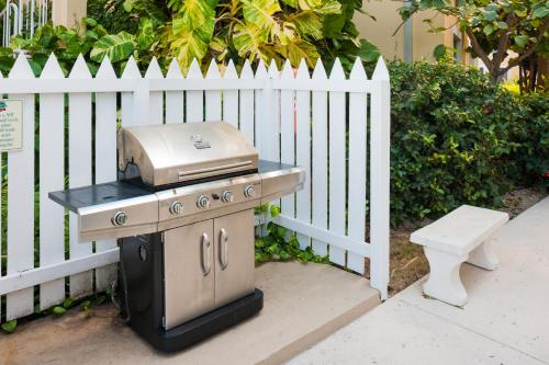 a grill sitting next to a white fence at Regal Beach Club in George Town