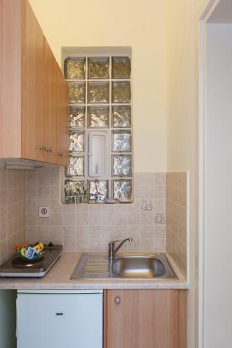 a kitchen with a sink and a counter top at Antouanetta Apartments in Ermoupoli