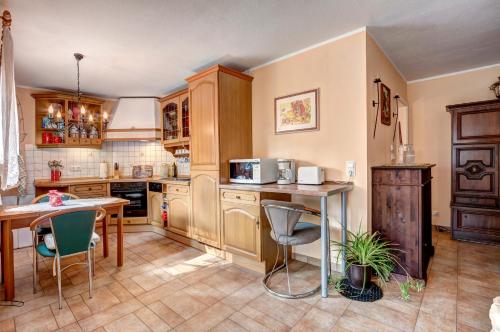 a kitchen with wooden cabinets and a table and chairs at Ferienhaus Matthies in Kolpinsee