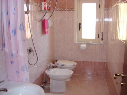a bathroom with a toilet and a shower and a sink at B&B Il Gabbiano in Reggio Calabria
