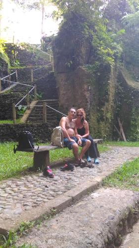 a man and a woman sitting on a bench at Bali Jungle Resort in Tegalalang
