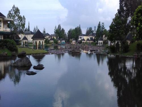 a large river with houses in the background at Villa Kota Bunga NA2 in Puncak