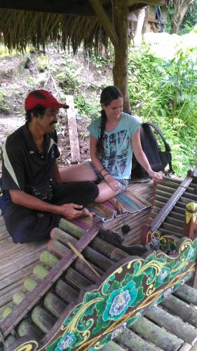 a man and a woman sitting on a bench at Bali Jungle Resort in Tegalalang