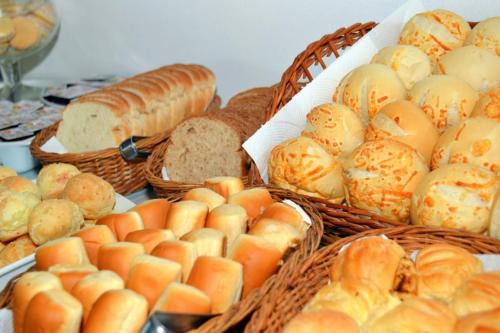 a bunch of baskets filled with bread and pastries at Coronado Inn Hotel in Búzios