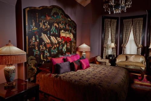 a bedroom with a large bed with pink pillows at The Inn at 97 Winder in Detroit