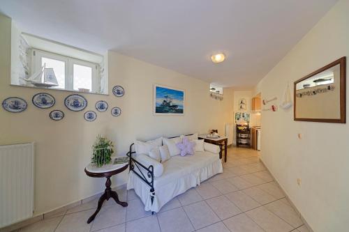 a living room with a bed and a table at Antouanetta Apartments in Ermoupoli