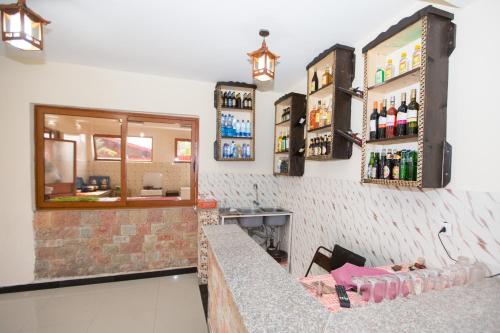 a bar in a restaurant with a counter with drinks at Honey Land Hotel Lalibela in Lalībela