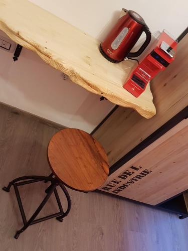 a wooden table with a bench and a tool on it at Terry's House in Nuoro