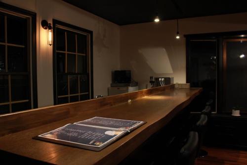 a bar with a book sitting on top of it at Nangoku Lodge Booya in Onna