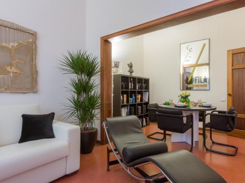 a living room with a couch and a table and chairs at Console House in Florence