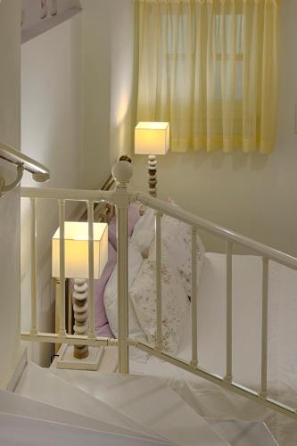 a small bed with a light on top of it at Antouanetta Apartments in Ermoupoli