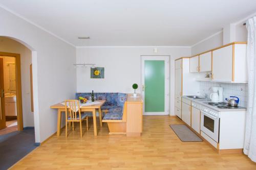 a kitchen with a table and a dining room at Ferienwohnungen Panorama Harrys Bike Tours in Villach