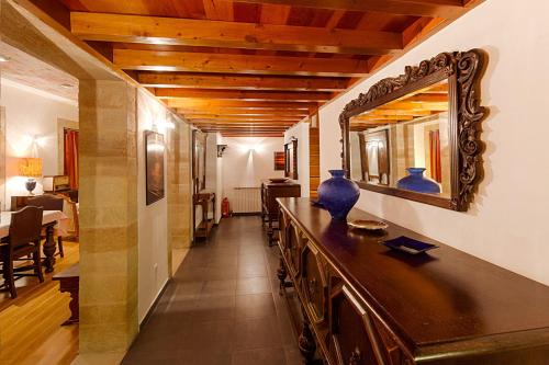 a hallway with a mirror and a table with a vase on it at In Camera Art Boutique Hotel in Rhodes Town