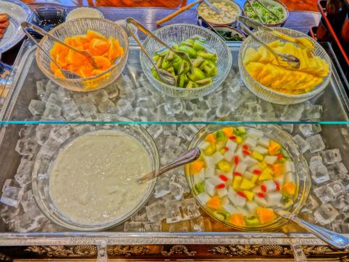 a glass table topped with bowls of different types of vegetables at Nest Hotel Matsuyama in Matsuyama