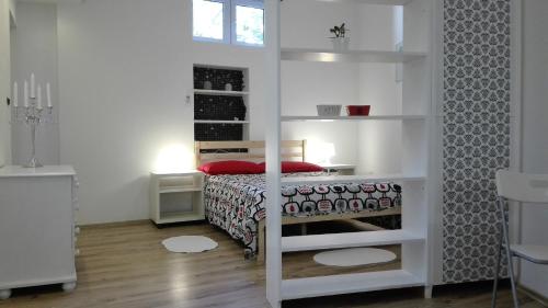 a bedroom with a bed in a white room at City Apartment Goga in Pula