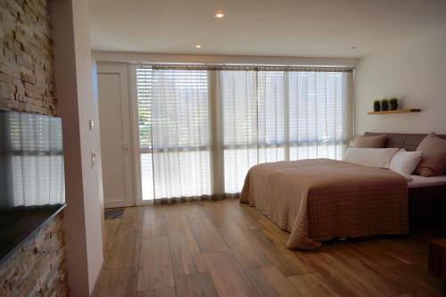 a bedroom with a bed and a large window at FeWo Dansenberg in Kaiserslautern