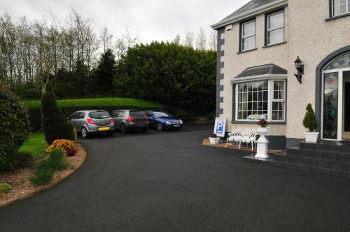 a group of cars parked in front of a house at Killererin House B&B in Letterkenny