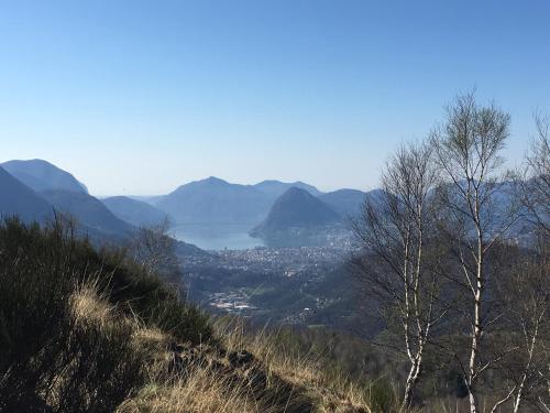 a view of a valley with mountains and a lake at Ristorante Stazione in Tesserete